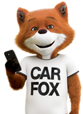 Car Fox smiling while holding a phone.